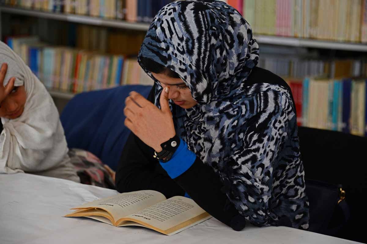 This photograph taken on January 9, 2016 shows Afghan woman Nadia, 20, reading love poems at a poetry club in Kandahar.