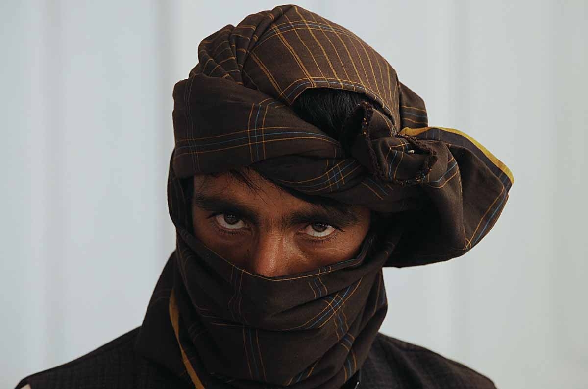 A former Taliban fighter looks on after he joined Afghan government forces during a ceremony in Herat on on June 26, 2013.