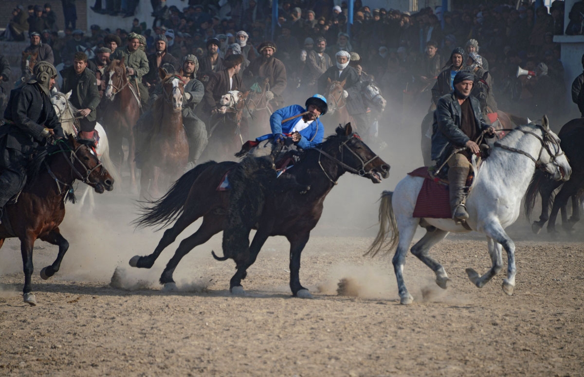 In this photograph taken on December 15, 2017, Afghan horsemen compete during a game of the traditional sport of Buzkashi in Mazar-i-Sharif.