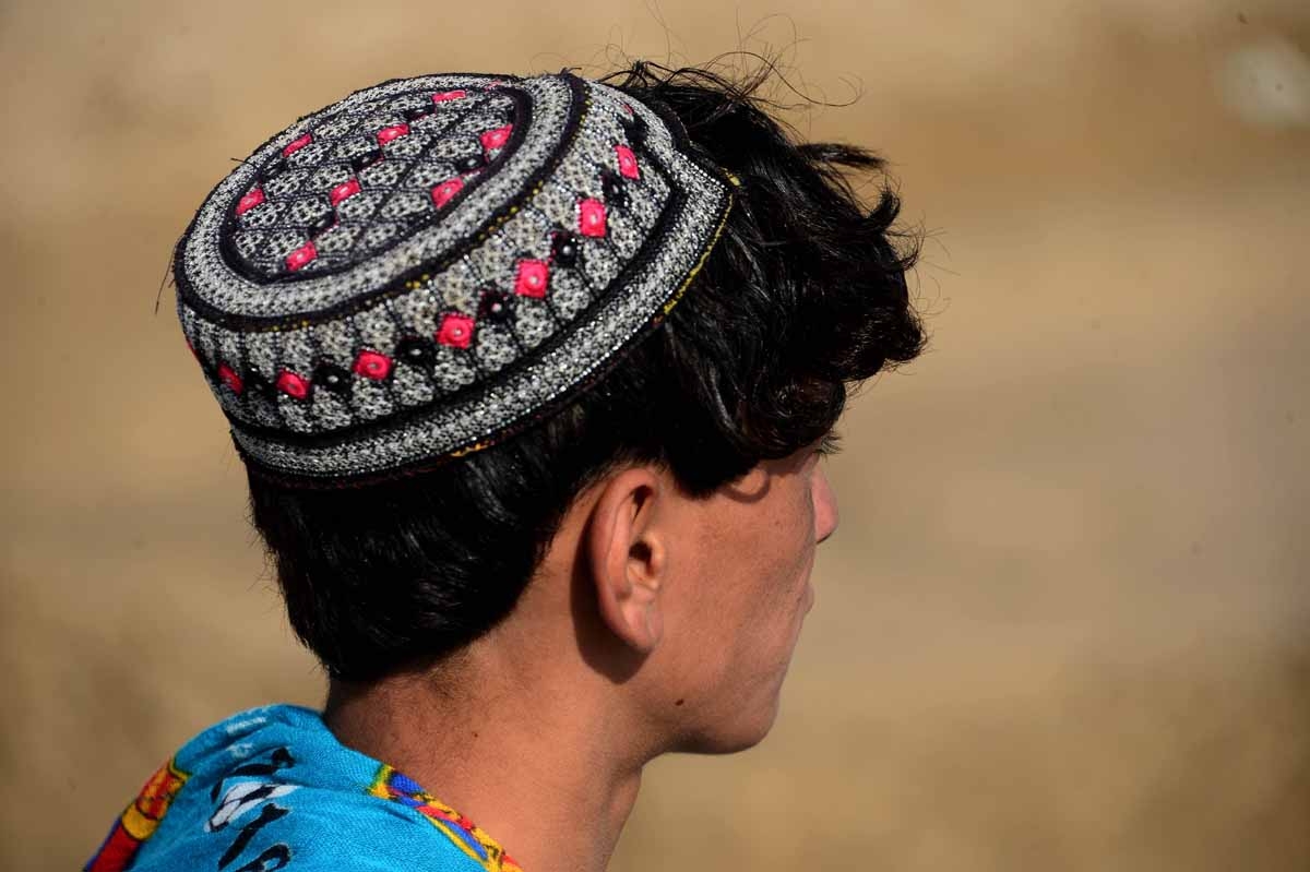 This file photo taken on October 31, 2016 shows an Afghan boy, who was held as a child sex slave, as he sits at a unidentified location in Afghanistan.