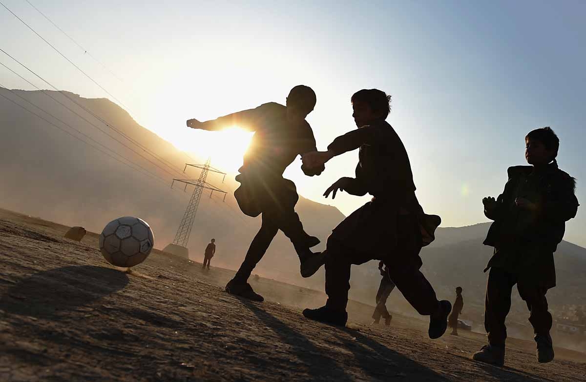 Afghan children play football in a field in Kabul on November 23, 2014. Football is one of the most popular games in Afghanistan and is played on dusty dry ground more often than grass. AFP PHOTO/SHAH Marai / AFP PHOTO / SHAH MARAI Afghan children play football in a field in Kabul on November 23, 2014. Football is one of the most popular games in Afghanistan and is played on dusty dry ground more often than grass. AFP PHOTO/SHAH Marai / AFP PHOTO / SHAH MARAI