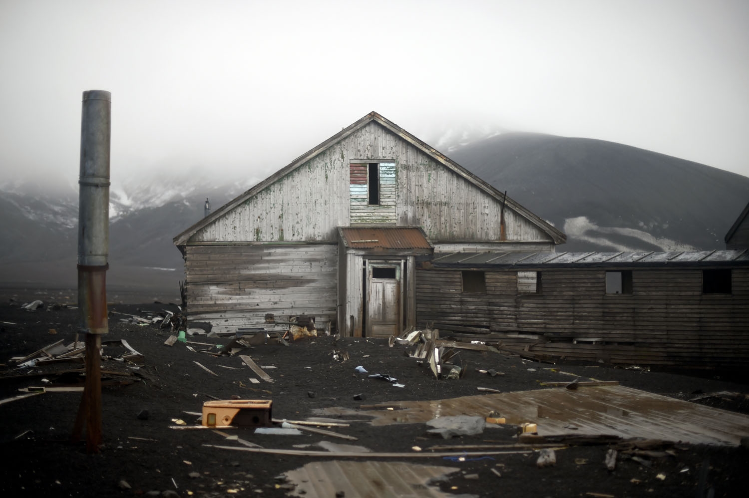 An old building of a British shipping base, which was consumed by a mudslide sparked by a volcano, crumbles at Whalers Bay in Deception Island, in the western Antarctica peninsula on March 06, 2016 antarctica-climate-tourism