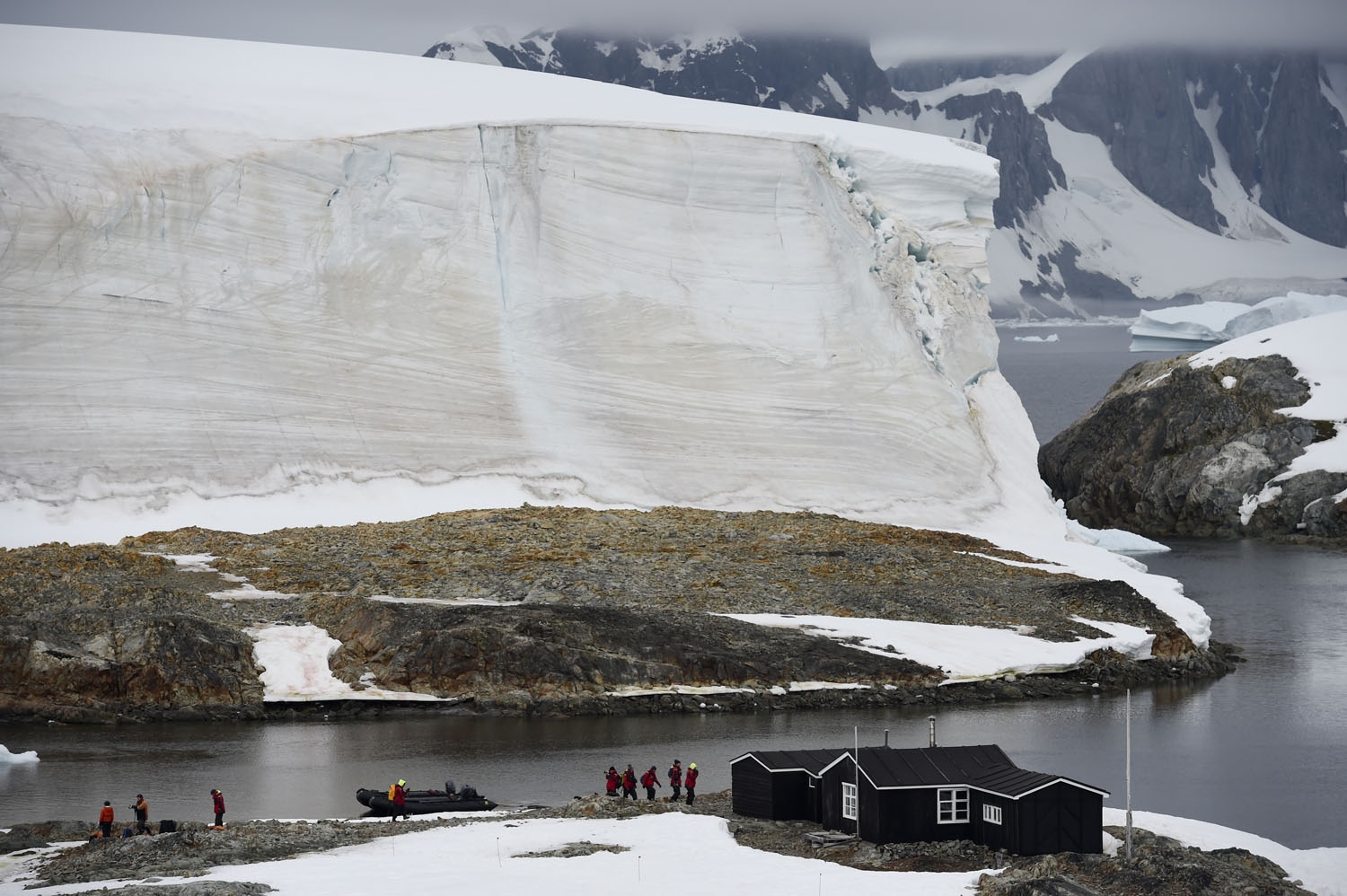 Tourists visit Wordie House, a hut built by the old British Graham Land Expedition (BGLE) and now a museum, in Winter Island, Antarctica, on March 02, 2016. Antarctica-environment-tourism