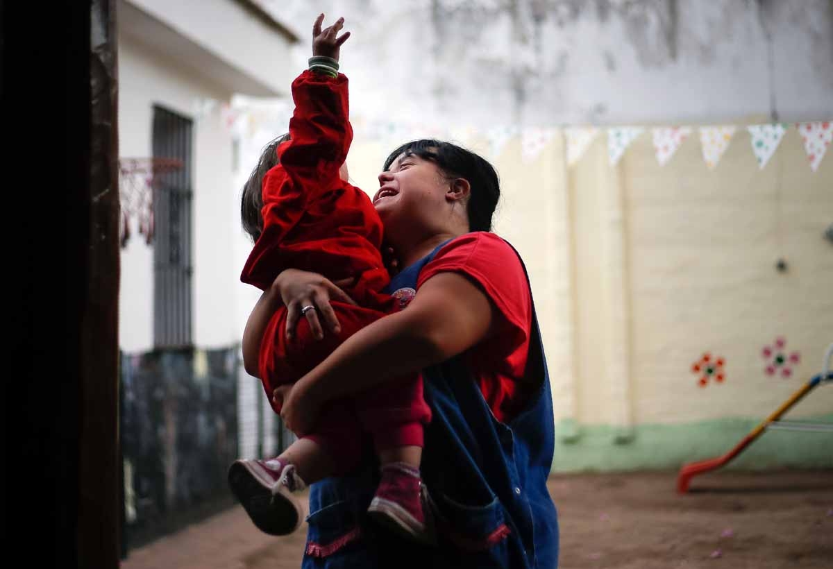 Noelia Garella (R), a kindergarten teacher born with Down Syndrome, plays with one year old child at the Jeromito kindergarten. Cordoba, Argentina on September 29, 2016. Noelia Garella (R), a kindergarten teacher born with Down Syndrome, plays with one year old child at the Jeromito kindergarten. Cordoba, Argentina on September 29, 2016.