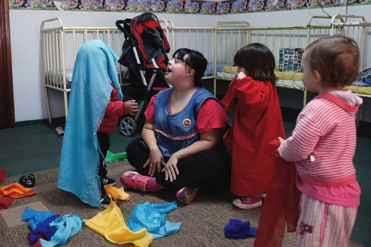 Noelia Garella (2-L), a kindergarten teacher born with Down Syndrome, plays with children at the Jeromito kindergarten in Cordoba, Argentina on September 29, 2016. Noelia Garella (2-L), a kindergarten teacher born with Down Syndrome, plays with children at the Jeromito kindergarten in Cordoba, Argentina on September 29, 2016.
