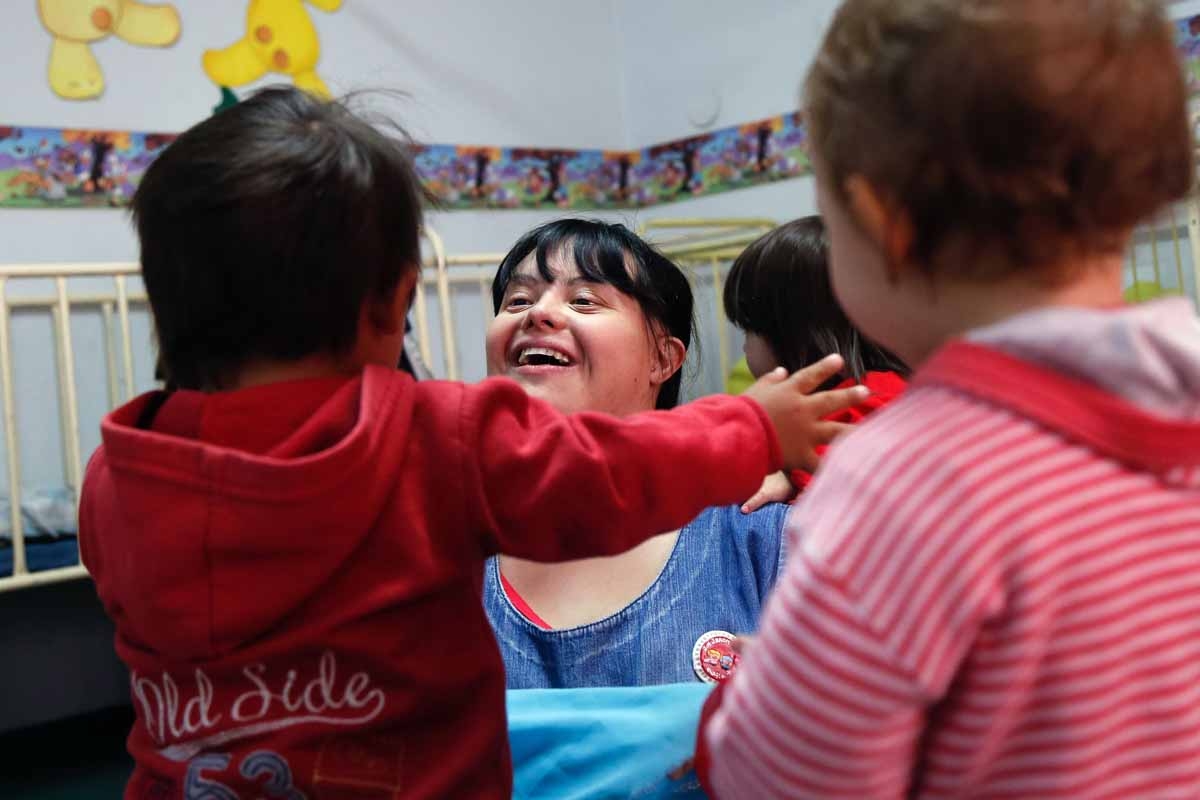 Noelia Garella (C), a kindergarten teacher born with Down Syndrome, plays with children at the Jeromito kindergarten in Cordoba, Argentina on September 29, 2016. Noelia Garella (C), a kindergarten teacher born with Down Syndrome, plays with children at the Jeromito kindergarten in Cordoba, Argentina on September 29, 2016.