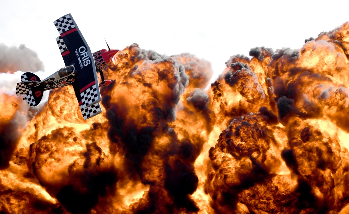 A member of the Tinstix of Dynamite aerobatics team flies in front of a wall of fire during the Australian International Airshow in Melbourne on March 5, 2017.