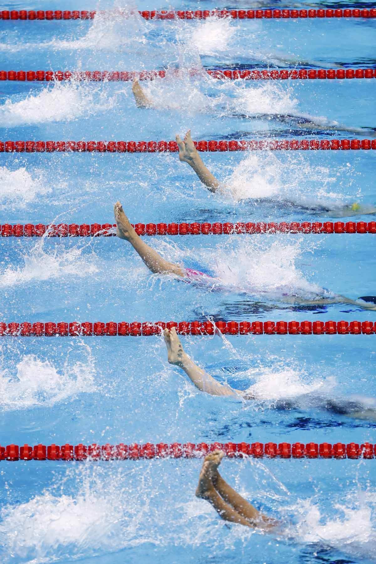 Swimmers compete in the Women's 100m Backstroke heats during the swimming event at the Rio 2016 Olympic Games at the Olympic Aquatics Stadium in Rio de Janeiro on August 7, 2016. Swimmers compete in the Women's 100m Backstroke heats during the swimming event at the Rio 2016 Olympic Games at the Olympic Aquatics Stadium in Rio de Janeiro on August 7, 2016.