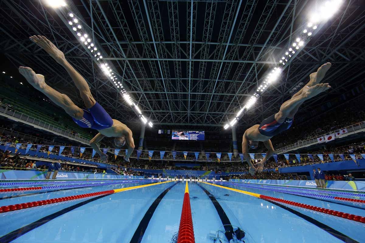 USA's Michael Phelps (L) takes the start of the Men's 200m Individual Medley Semifinal during the swimming event at the Rio 2016 Olympic Games at the Olympic Aquatics Stadium in Rio de Janeiro on August 10, 2016. USA's Michael Phelps (L) takes the start of the Men's 200m Individual Medley Semifinal during the swimming event at the Rio 2016 Olympic Games at the Olympic Aquatics Stadium in Rio de Janeiro on August 10, 2016.