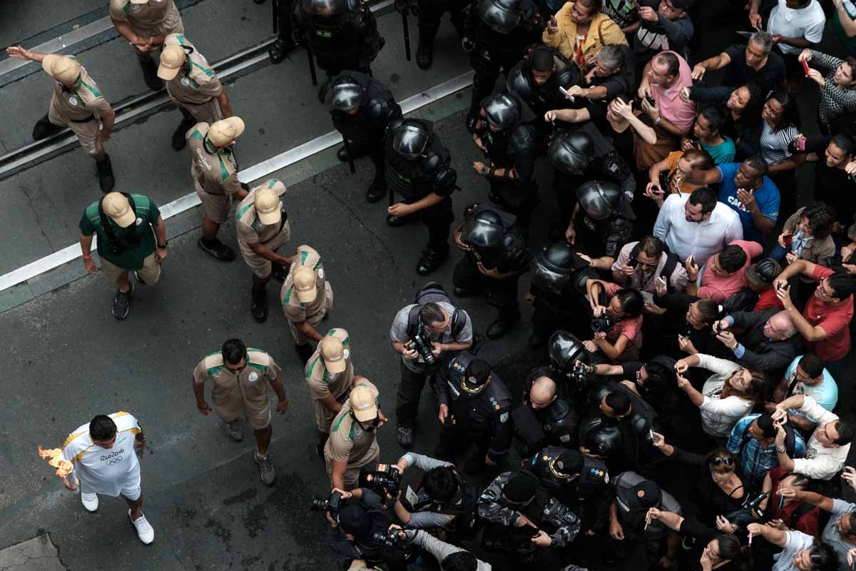 An Olympic torch bearer runs through the city centre as the Olympic flame is paraded through Rio de Janeiro on August 3, 2016 ahead of the Rio 2016 Olympic Games. An Olympic torch bearer runs through the city centre as the Olympic flame is paraded through Rio de Janeiro on August 3, 2016 ahead of the Rio 2016 Olympic Games.