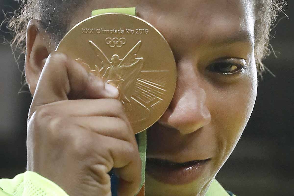 Brazil's Rafaela Silva celebrates with her gold medal following the women's -57kg judo contest of the Rio 2016 Olympic Games in Rio de Janeiro on August 8, 2016. Brazil's Rafaela Silva celebrates with her gold medal following the women's -57kg judo contest of the Rio 2016 Olympic Games in Rio de Janeiro on August 8, 2016.