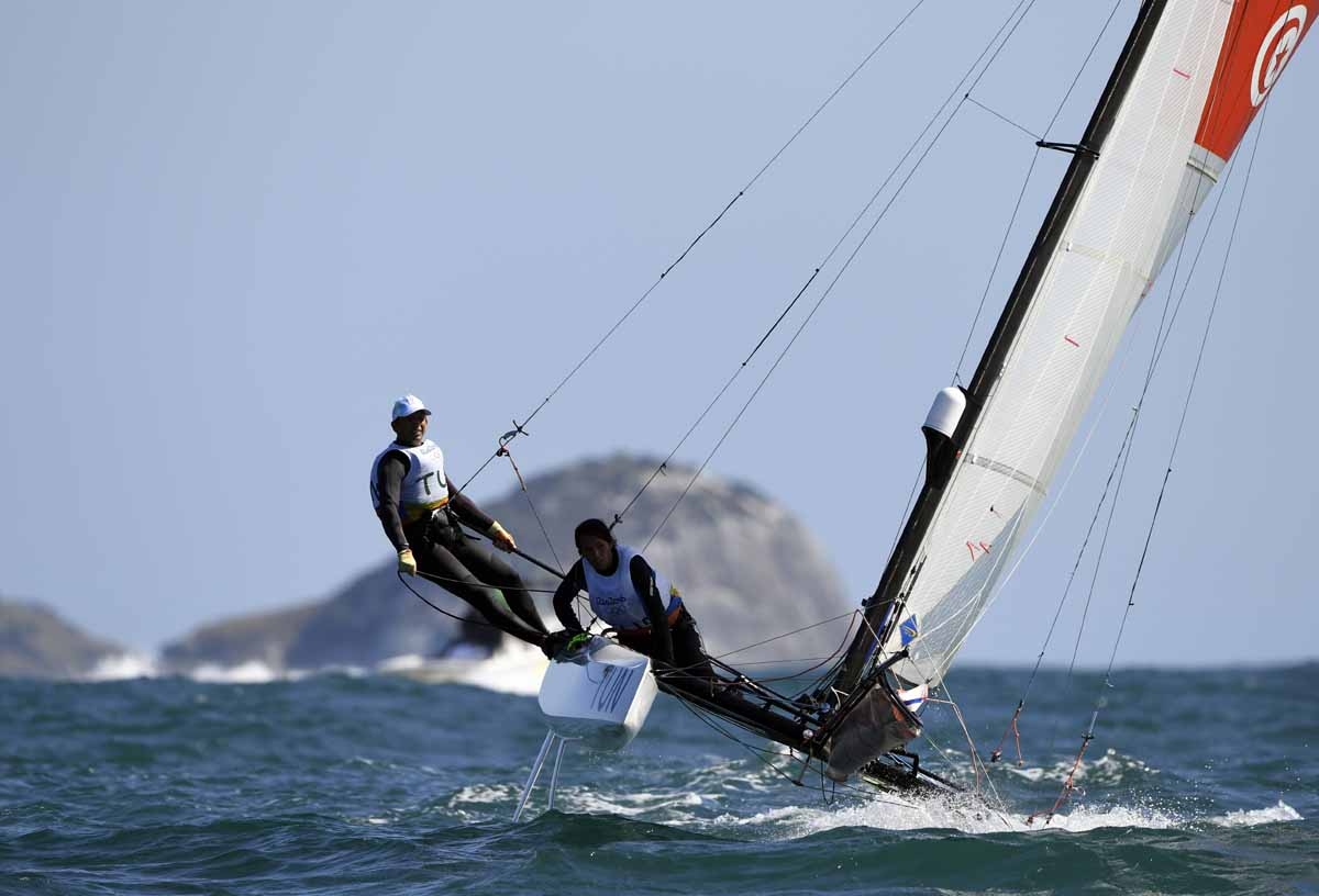 Tunisia's Riheb Hammami and Tunisia's Hedi Gharbi compete in the Nacra 17 Mixed sailing class on Guanabara Bay in Rio de Janerio during the Rio 2016 Olympic Games on August 13, 2016. Tunisia's Riheb Hammami and Tunisia's Hedi Gharbi compete in the Nacra 17 Mixed sailing class on Guanabara Bay in Rio de Janerio during the Rio 2016 Olympic Games on August 13, 2016.