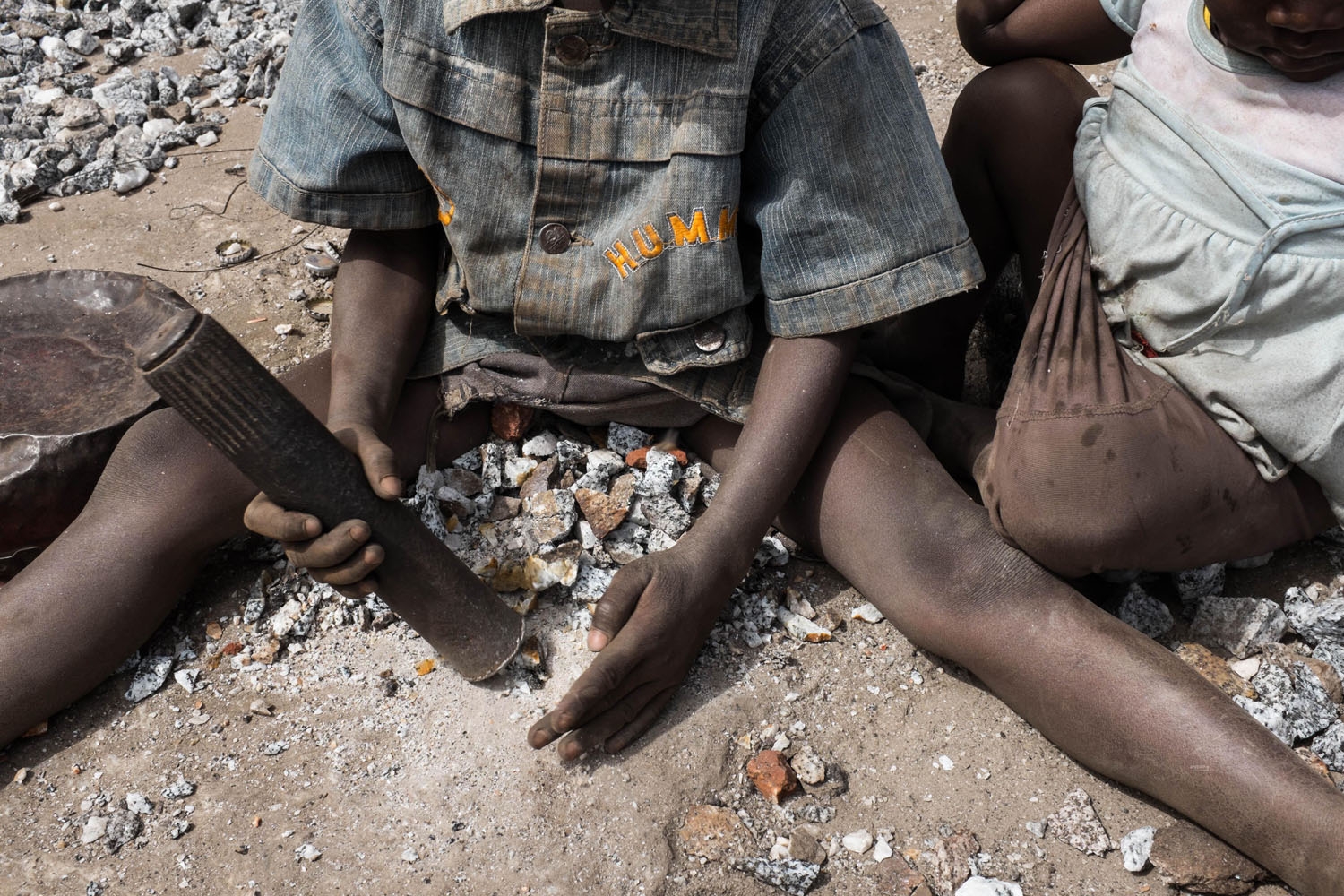 A young boy crushes stones in a quarry in Ouagadougou on December 21, 2015 where adults and children work.