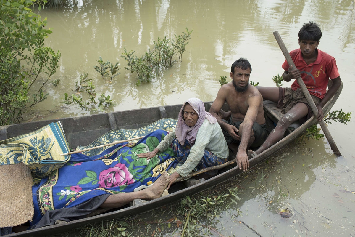 EDITORS NOTE: Graphic content / The bodies of Rohingya refugee are brought to shore on a boat by fellow Rohingyas after being recovered on the Naf river, as scores of refugees tried to flee from Myanmar to Bangladesh, near Ulubunia in Ukhiya on September