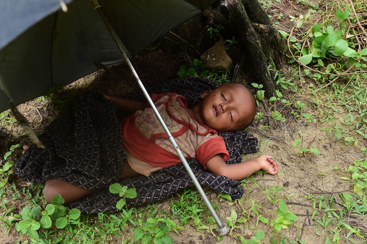 A Rohingya Muslim child sleeps after crossing the border from Myanmar, near the Bangladeshi town of Teknaf on September 10, 2017.