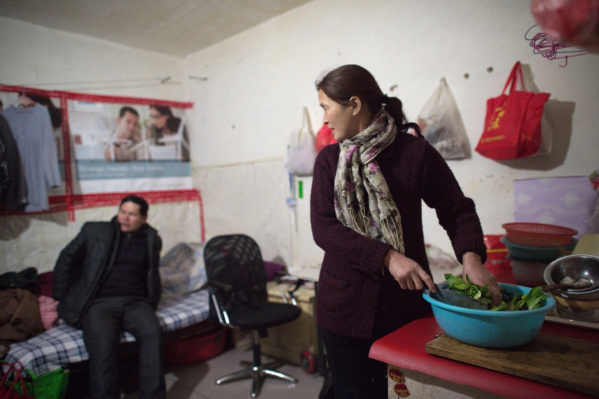 This picture taken on February 16, 2017 shows Mr and Mrs Yang (given names not available) inside their 9 square metres room in the Heiqiaocun migrant village in Beijing.