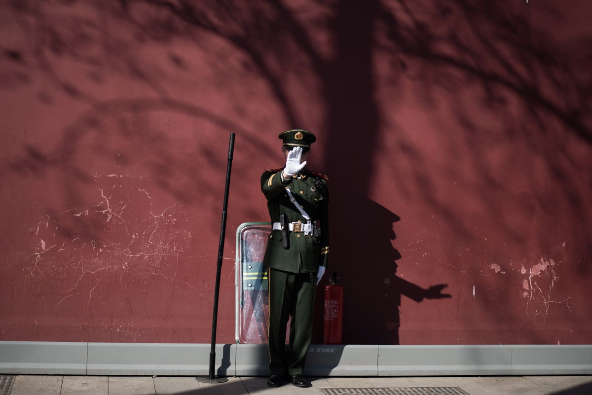 A paramilitary guard gestures not to be photographed at the gate of the Forbidden City ahead of upcoming opening sessions of the Chinese People's Political Consultative Conference (CPPCC) and the National People's Congress (NPC) in Beijing on March 1, 201