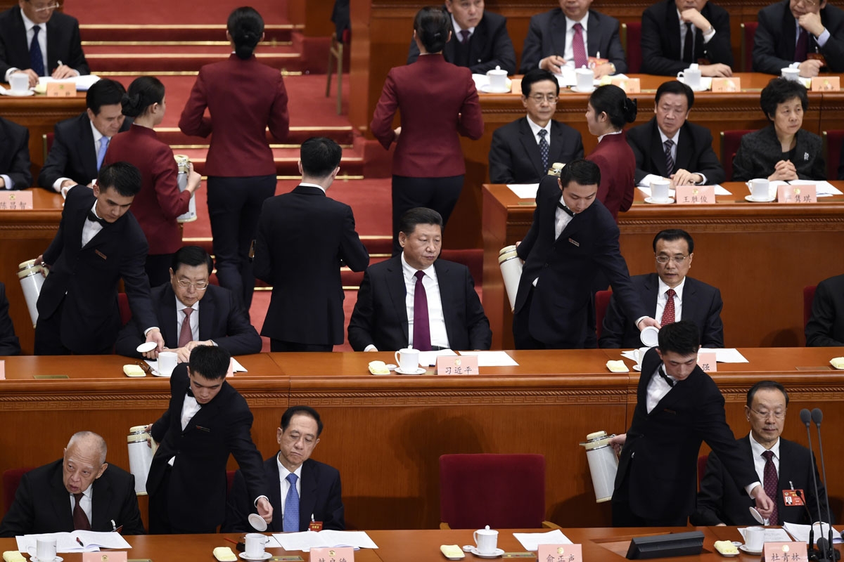 Chinese hostesses serve tea to delegates during the opening session of the Chinese People's Political Consultative Conference (CPPCC) at the Great Hall of the People in Beijing on March 3, 2017.