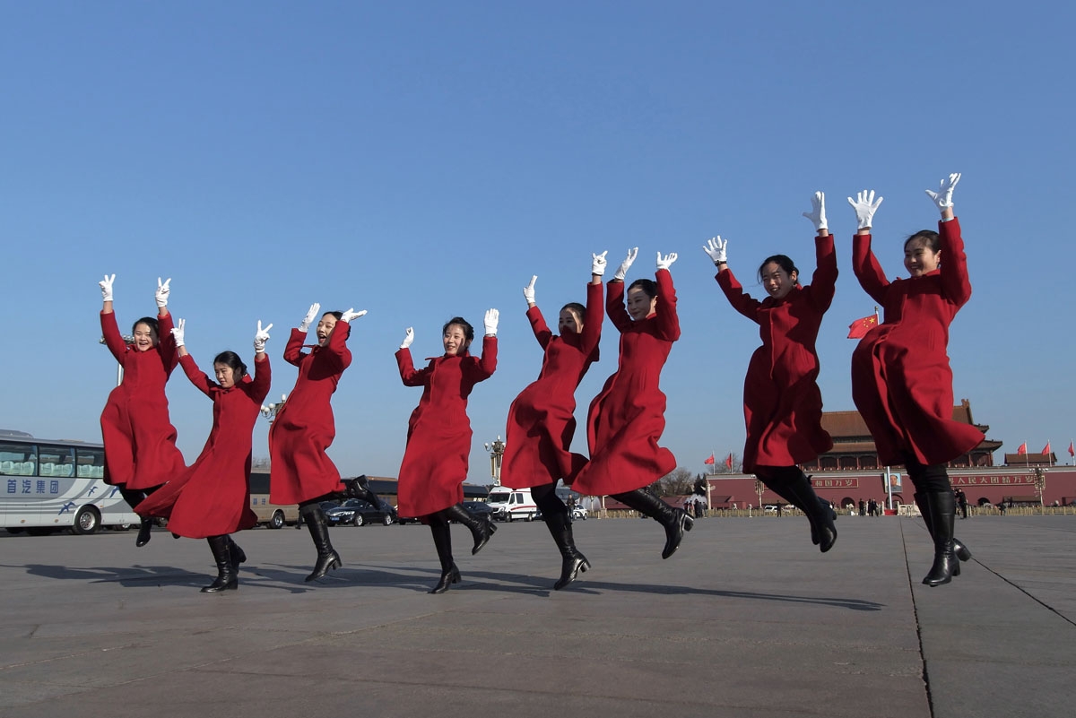 Hostesses jump as they pose for a picture during the opening of the National People's Congress in Beijing on March 5, 2017. China's rubber-stamp congress opened on March 5 in an annual pageant of Communist-controlled democracy.