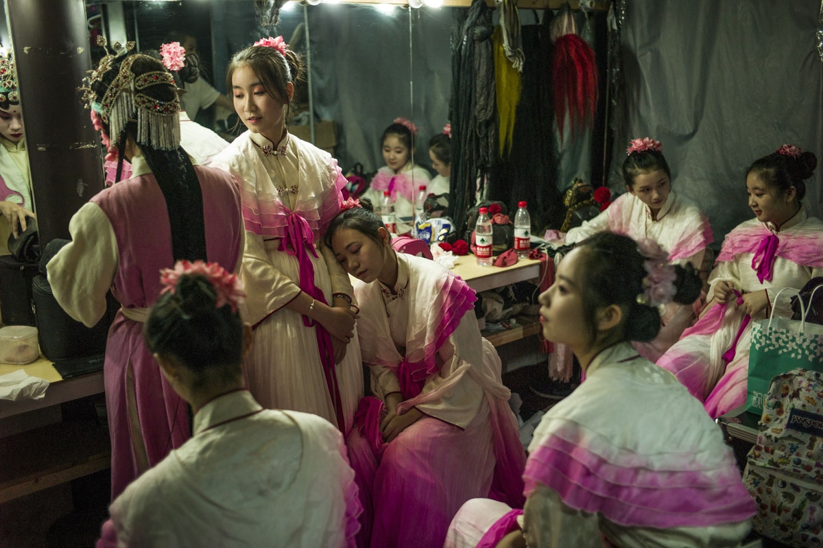 Chinese actors prepare to perform the outdoor Peking Opera in Zhujiajiao on the outskirts of Shanghai on September 10, 2016.