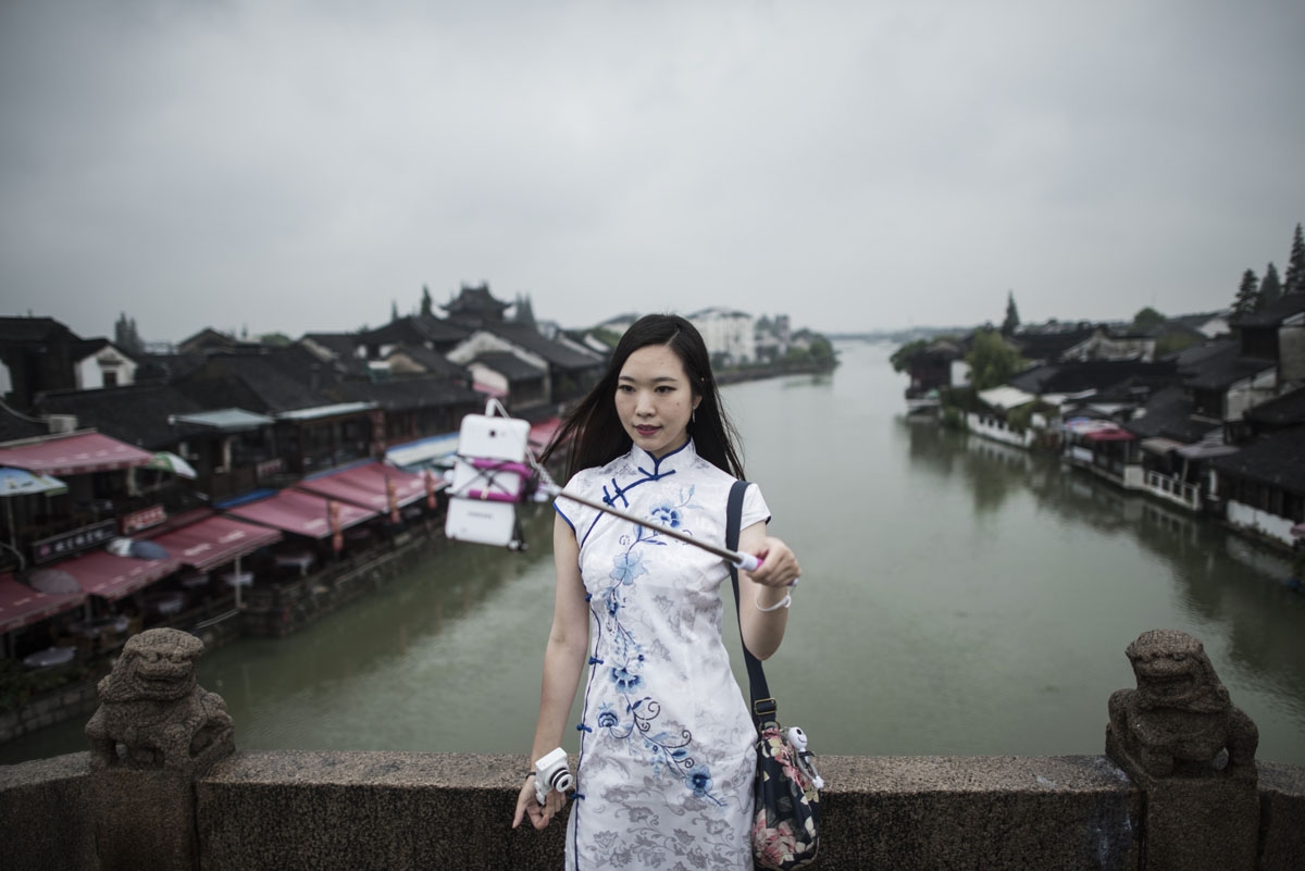 In this picture taken on September 7, 2016, a woman takes a selfie in Zhujiajiao, on the outskirts of Shanghai