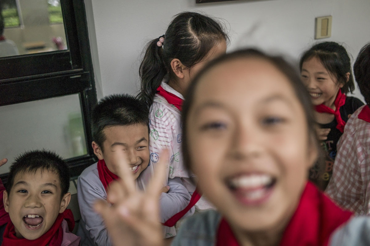 In this picture taken on September 8, 2016, students pose for a picture at the elementary school in Zhujiajiao, on the outskirts of Shanghai