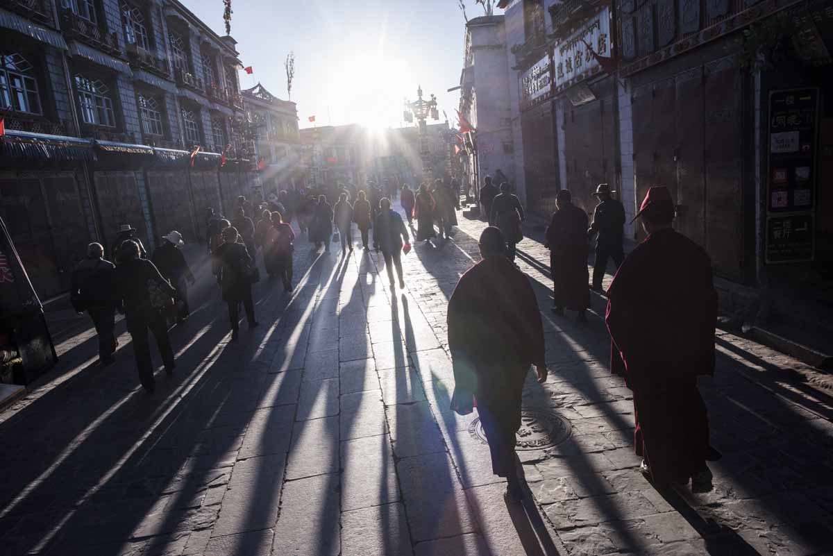 This picture taken on September 10, 2016 shows pilgrims praying and prostrating outside the Jokhang Temple in the regional capital Lhasa, in China's Tibet Autonomous Region. 