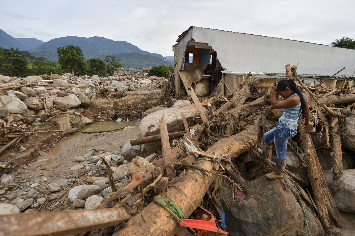 A woman gestures amid the damage caused by mudslides following heavy rains in Mocoa, Putumayo department, southern Colombia on April 2, 2017.