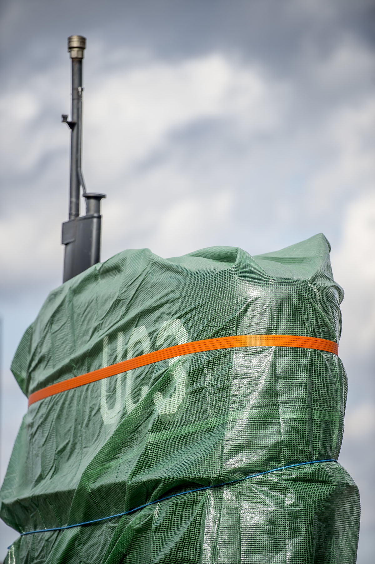 A picture taken on April 25, 2018 shows a detail of the homemade submarine UC3 Nautilus as it is covered with green tarpaulin in Nordhavn, a harbour area in Copenhagen, Denmark.