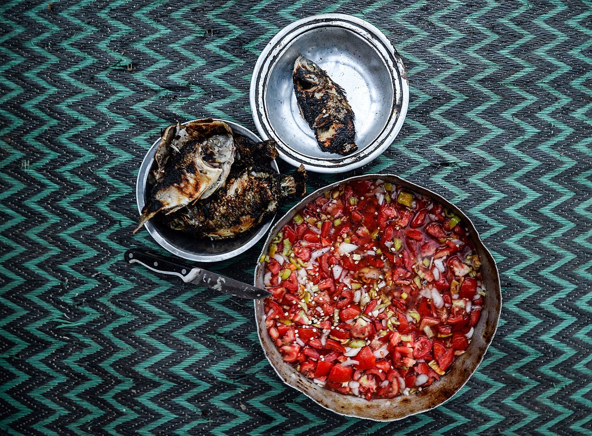 his picture taken on June 16, 2018, shows a fisheman's meal, near the Pharaonic Sea, in the village of Kafr Fisha, province of Munuf. The Pharaonic Sea is the name of a large water body in the province of Menoufia, an area of 2500 acres and overlooking 50