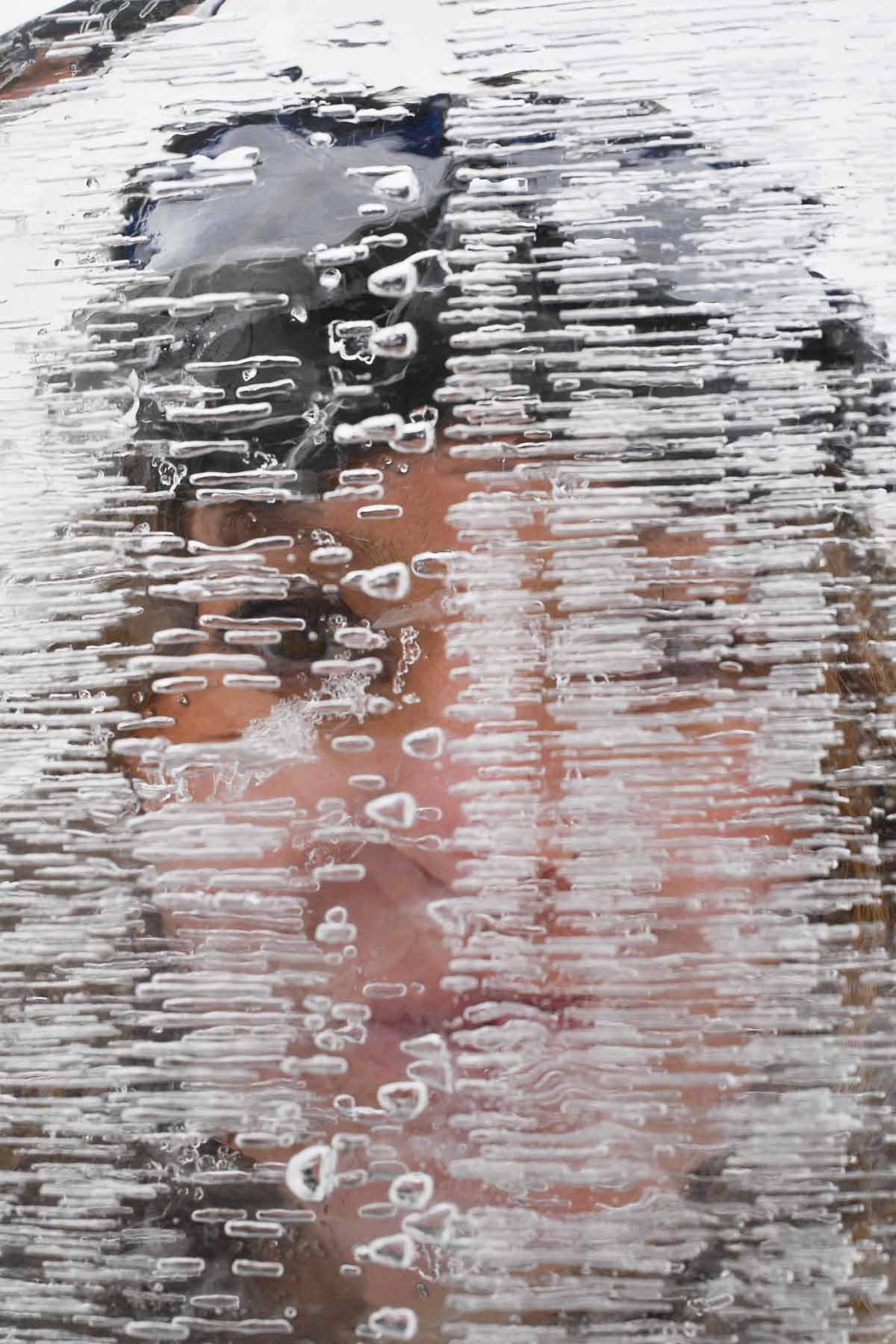 ohanna Nordblad, 42, Finnish freediver looks through a piece of ice on a frozen lake during a Ice-freediving training session on February 28, 2017, in Somero (southwest Finland).