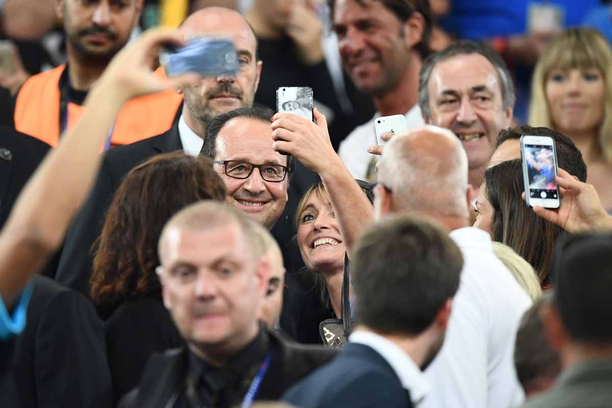 French President Francois Hollande poses for selfies at the end of the Euro 2016 semi-final football match between Germany and France at the Stade Velodrome in Marseille on July 7, 2016. France will face Portugal in the Euro 2016 finals on July 10, 2016. French President Francois Hollande poses for selfies at the end of the Euro 2016 semi-final football match between Germany and France at the Stade Velodrome in Marseille on July 7, 2016. France will face Portugal in the Euro 2016 finals on July 10, 2016.