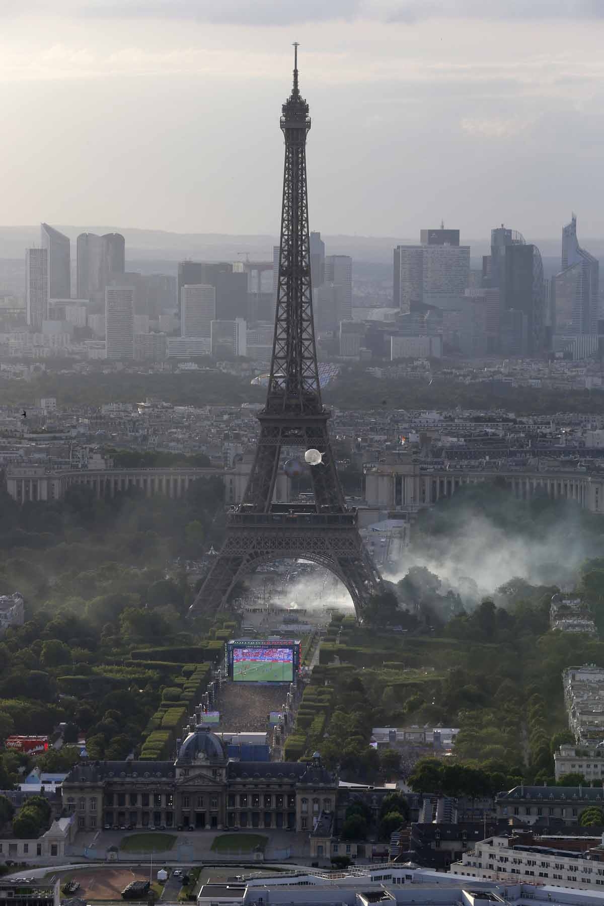 A picture taken from the Tour Montparnasse shows tear gas under the Eiffel tower during clashes between police and supporters trying to illegally enter the Champs de Mars fan zone on July 10, 2016 in Paris, before the Euro 2016 football tournament final m A picture taken from the Tour Montparnasse shows tear gas under the Eiffel tower during clashes between police and supporters trying to illegally enter the Champs de Mars fan zone on July 10, 2016 in Paris, before the Euro 2016 football tournament final m