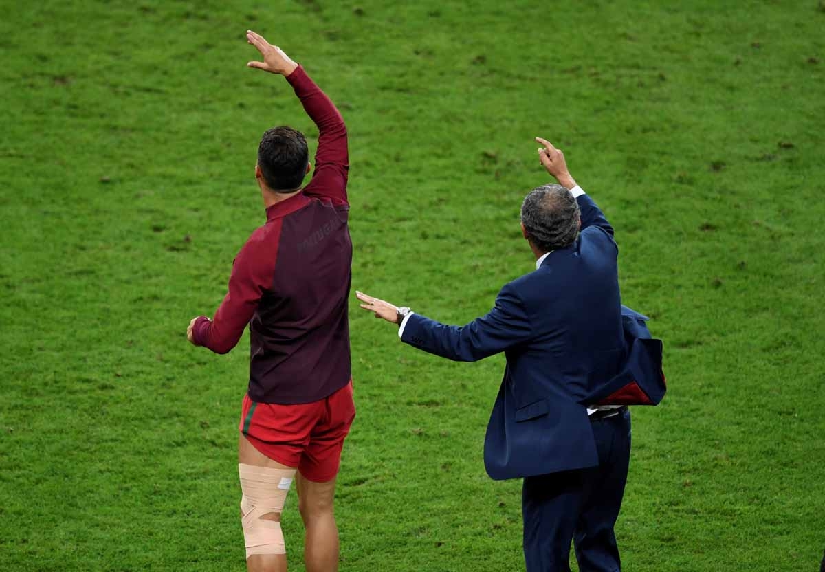 Portugal's forward Cristiano Ronaldo (L) and Portugal's coach Fernando Santos celebrate their team's win in the Euro 2016 final football match between Portugal and France at the Stade de France in Saint-Denis, north of Paris, on July 10, 2016. / AFP PHOTO Portugal's forward Cristiano Ronaldo (L) and Portugal's coach Fernando Santos celebrate their team's win in the Euro 2016 final football match between Portugal and France at the Stade de France in Saint-Denis, north of Paris, on July 10, 2016. / AFP PHOTO