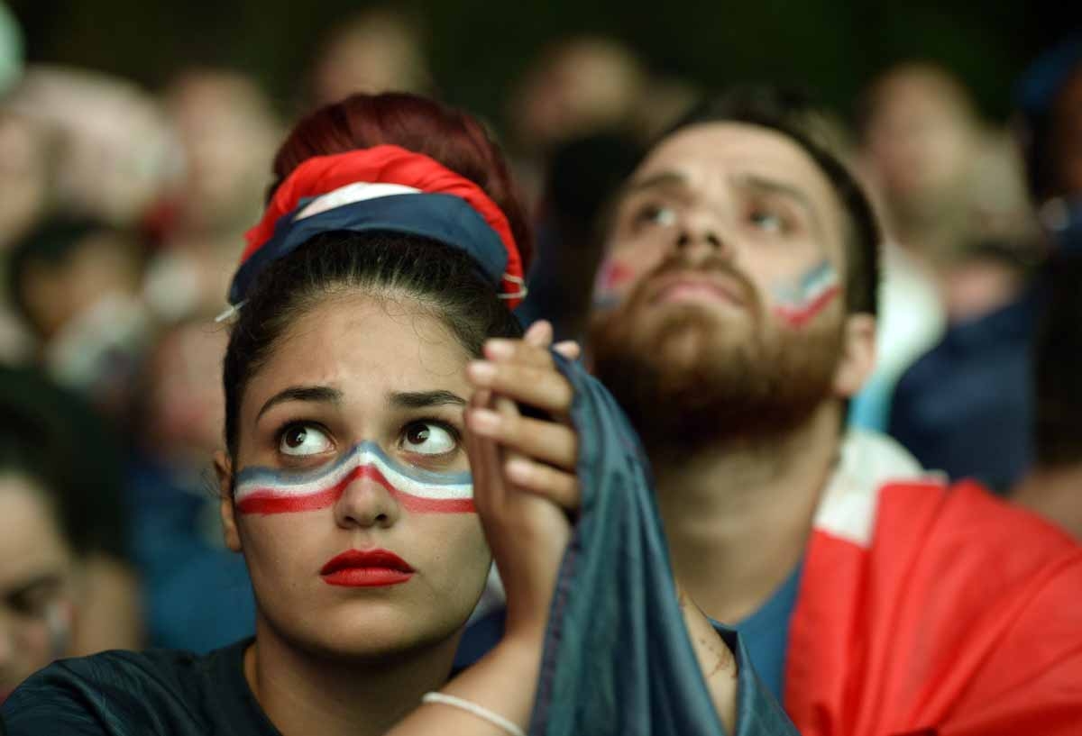 A French supporter reacts after the Euro 2016 final football match between Portugal and France at the Champ-de-Mars fan zone in Paris on July 10, 2016. Ronaldo's Portugal beat France 1-0 in Euro 2016 final. / AFP PHOTO / ALAIN JOCARD A French supporter reacts after the Euro 2016 final football match between Portugal and France at the Champ-de-Mars fan zone in Paris on July 10, 2016. Ronaldo's Portugal beat France 1-0 in Euro 2016 final. / AFP PHOTO / ALAIN JOCARD