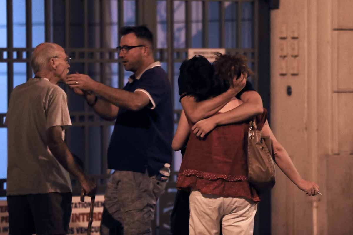 People react in the French Riviera town of Nice on July 15, 2016, after a van drove into a crowd watching a fireworks display. People react in the French Riviera town of Nice on July 15, 2016, after a van drove into a crowd watching a fireworks display.