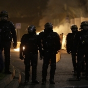 Anti riot police officers stand guard during a protest in Bobigny, a district of northeast Paris, to denounce police brutality after a black man was allegedly sodomised with a baton during an arrest while in their custody in Paris on February 11, 2017.