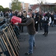 A man pours gasoline on pallets outside the Fleury-Merogis prison, near Paris, on April 10, 2017, during a demonstration by prison guards after six of their colleagues were injured by inmates.