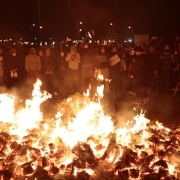 Protesters stand behind a burning barricade outside the Fleury-Merogis prison, near Paris, on April 10, 2017, during a demonstration by prison guards after six of their colleagues were injured by inmates.