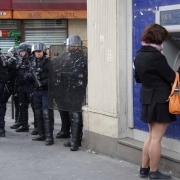 French anti-riot policemen stand guard the street during a demonstration for a social first round of the French presidential election on April 22, 2017 on the place de la Republique in Paris.