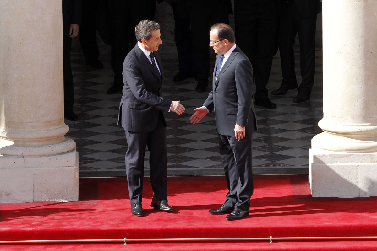 France's president Nicolas Sarkozy (L) welcomes his successor Francois Hollande upon his arrival at the Elysee Palace for the formal investiture ceremony between France's president Francois Hollande and his predecessor Nicolas Sarkozy, at the Elysee presi