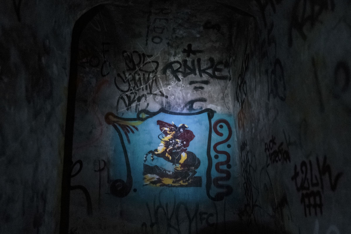 This photograph taken on October 31, 2017, shows the painted wall of the 'Bonaparte' staircase in the banned catacombs of Paris.