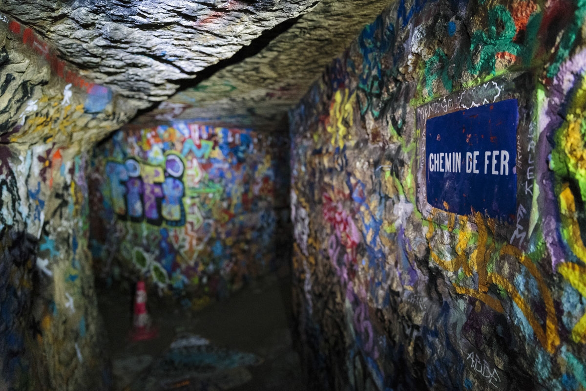 In this photograph taken on November 7, 2017, shows a street sign in a colorful part of the banned catacombs of Paris.