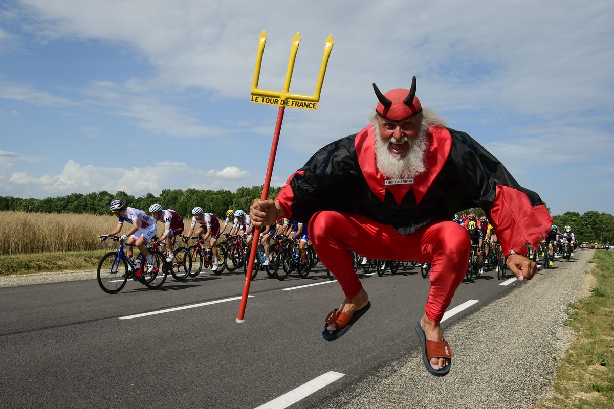German supporter Didi Senft known as El Diablo jumps as the pack ride during the 213,5 km seventh stage of the 104th edition of the Tour de France cycling race on July 7, 2017 between Troyes and Nuits-Saint-Georges.
