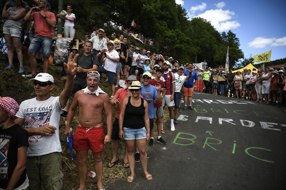 Supporters cheer along the road during the 189,5 km fifteenth stage of the 104th edition of the Tour de France cycling race on July 16, 2017 between Laissac-Severac l'Eglise and Le Puy-en-Velay.