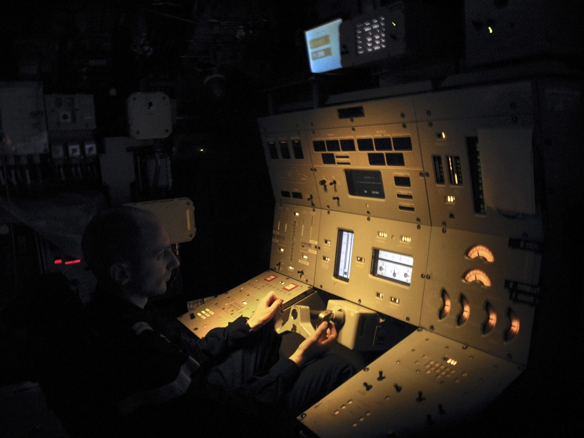 This photo taken on October, 2016 aboard the French Navy's Triumphant-class strategic nuclear submarine Le Vigilant, shows the helmsman in the submarine's control room.
