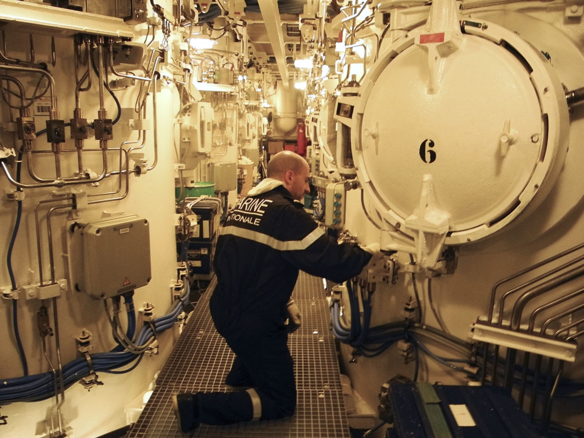This photo taken on October, 2016 off the coast of Brest aboard the French Navy's Triumphant-class strategic nuclear submarine Le Vigilant, shows a sailor in the M51 SLBM ballistic missiles compartments room.