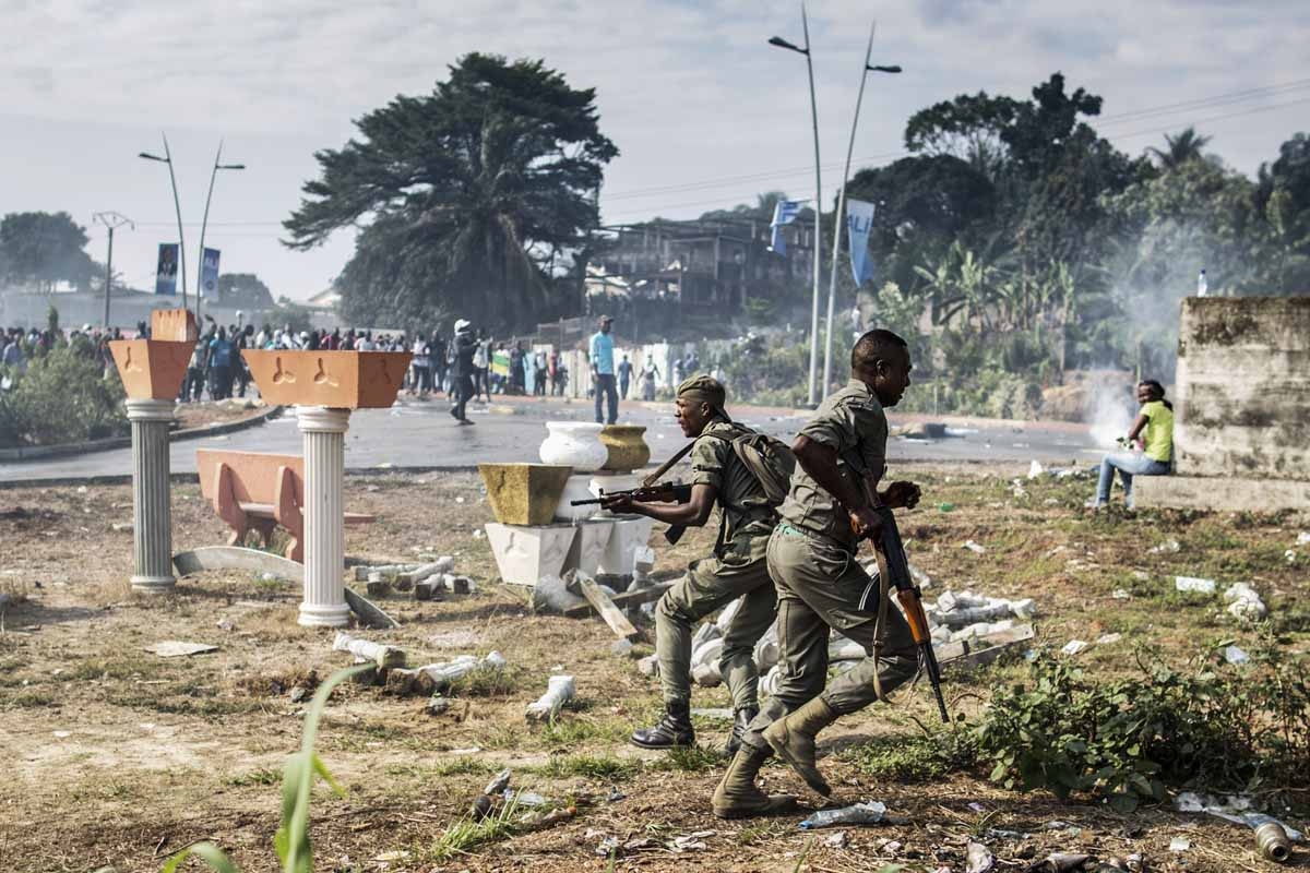 Gabonese soldiers run to take position as supporters of opposition leader Jean Ping protest in front of security forces blocking a demonstration trying to reach the electoral commission in Libreville on August 31, 2016. Gabonese soldiers run to take position as supporters of opposition leader Jean Ping protest in front of security forces blocking a demonstration trying to reach the electoral commission in Libreville on August 31, 2016.