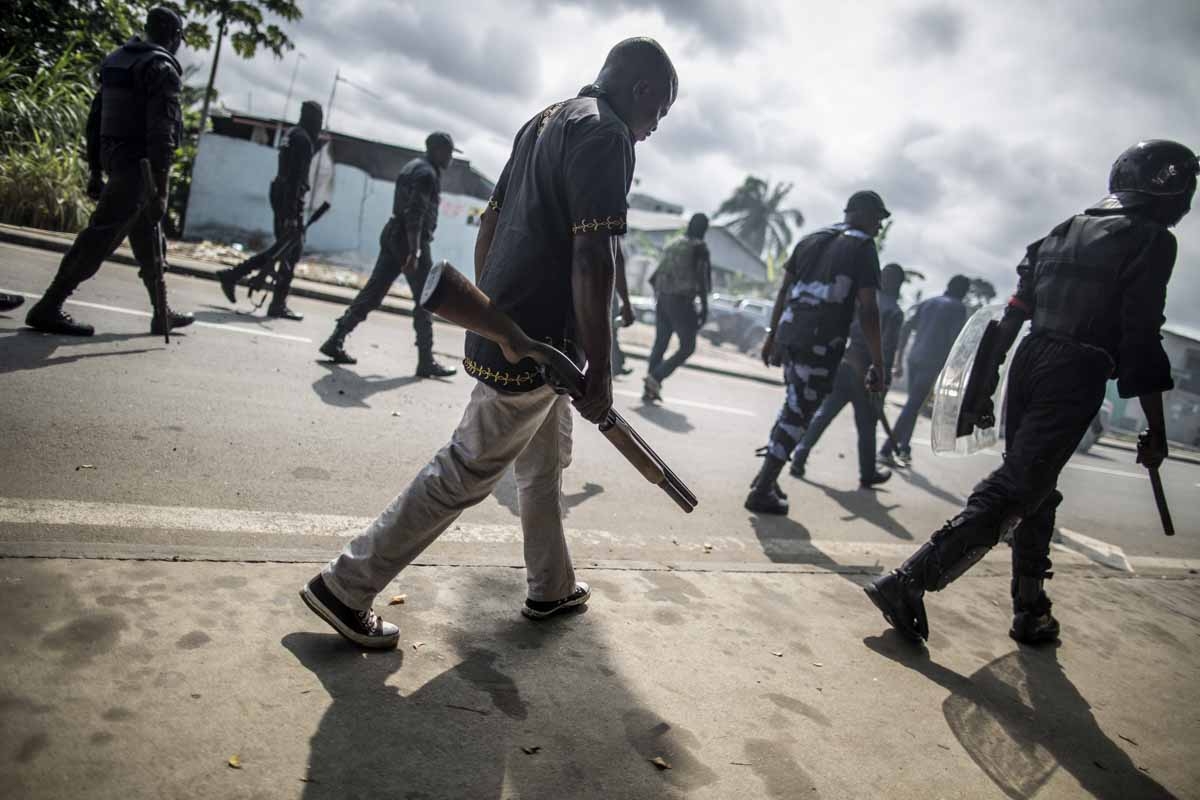 Gabonese police forces patrol as they clear barricades in the streets adjacent to the National Assembly, in Libreville, on September 1, 2016. Gabonese police forces patrol as they clear barricades in the streets adjacent to the National Assembly, in Libreville, on September 1, 2016.