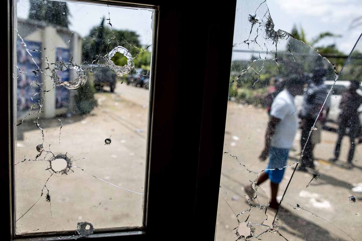 This photo taken on September 3, 2016 in Libreville shows bullet holes in the window of a guard post on the gate of Gabon's opposition leader Jean Ping's headquarters. This photo taken on September 3, 2016 in Libreville shows bullet holes in the window of a guard post on the gate of Gabon's opposition leader Jean Ping's headquarters.